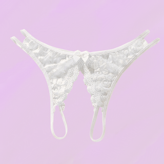 the white crotchless panties lying on a soft purple background