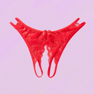 the red crotchless panties lying on a soft purple background