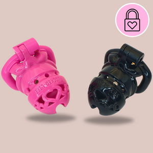 The Locked Life Chastity Cages from House Of Chastity, they are shown here in pink and black, with the words LOCKED LIFE and SEX SLAVE imprinted on the top.