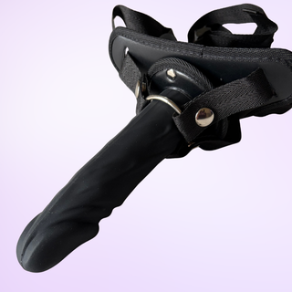 The Lumen Glide strap on dildo fully assembled with the steel ring