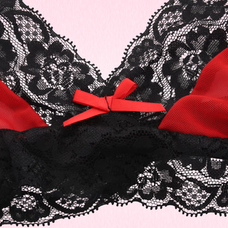 A close up of the lace and mesh fabric and the bow detailing.
