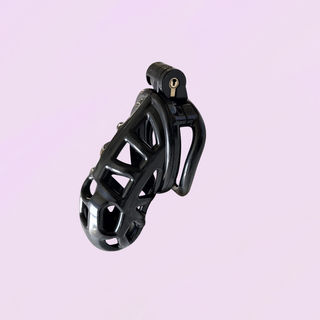 The Onyx Restraint small chastity cage fully assembled on a soft purple background