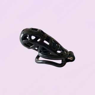 The chastity cage is sitting on its curved base ring, the cage is fully asssembled on a soft purple background