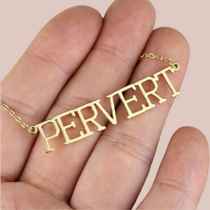 The gold Pervert necklace is shown being held to provide an idea of size.