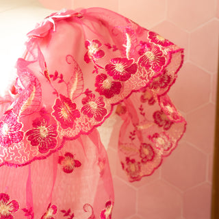 A close up of the draped sleeve with bow detailing.