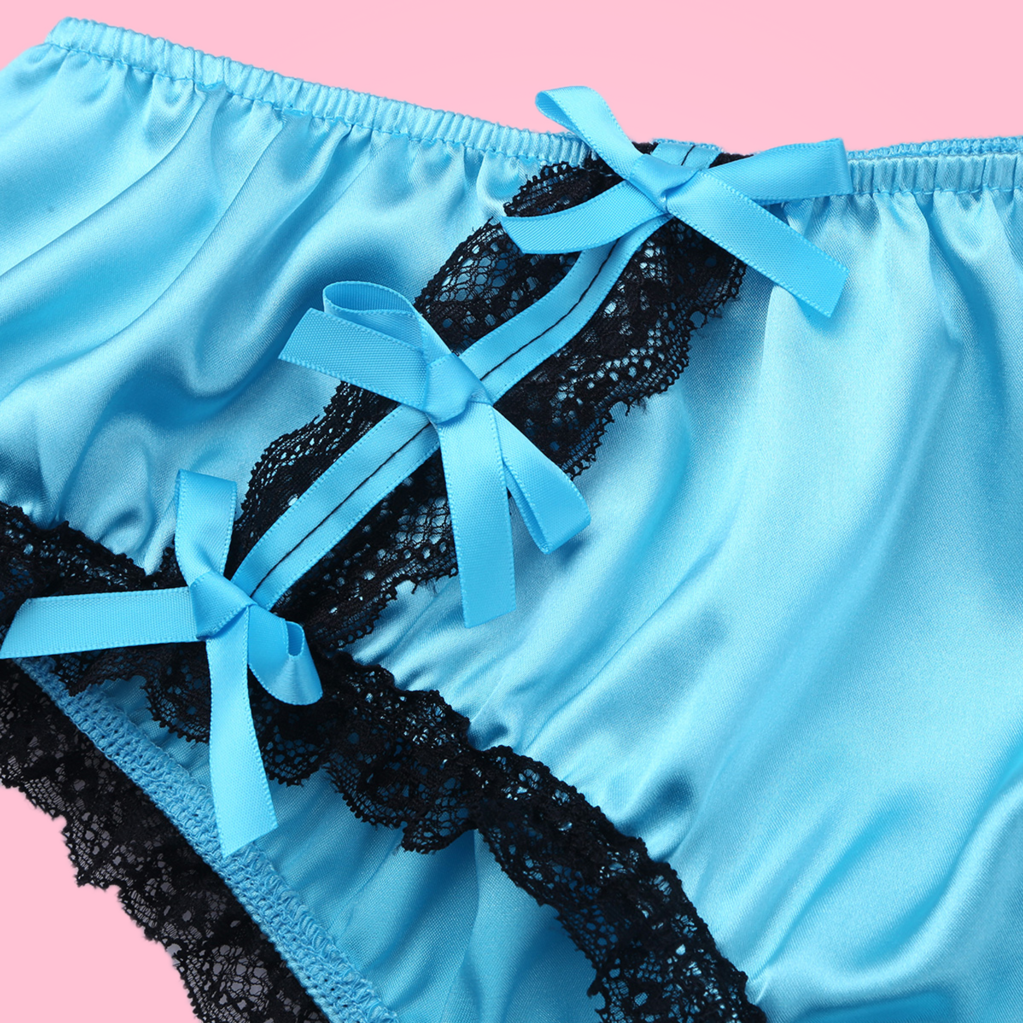 A close up of the blue satin bows and lace detailing