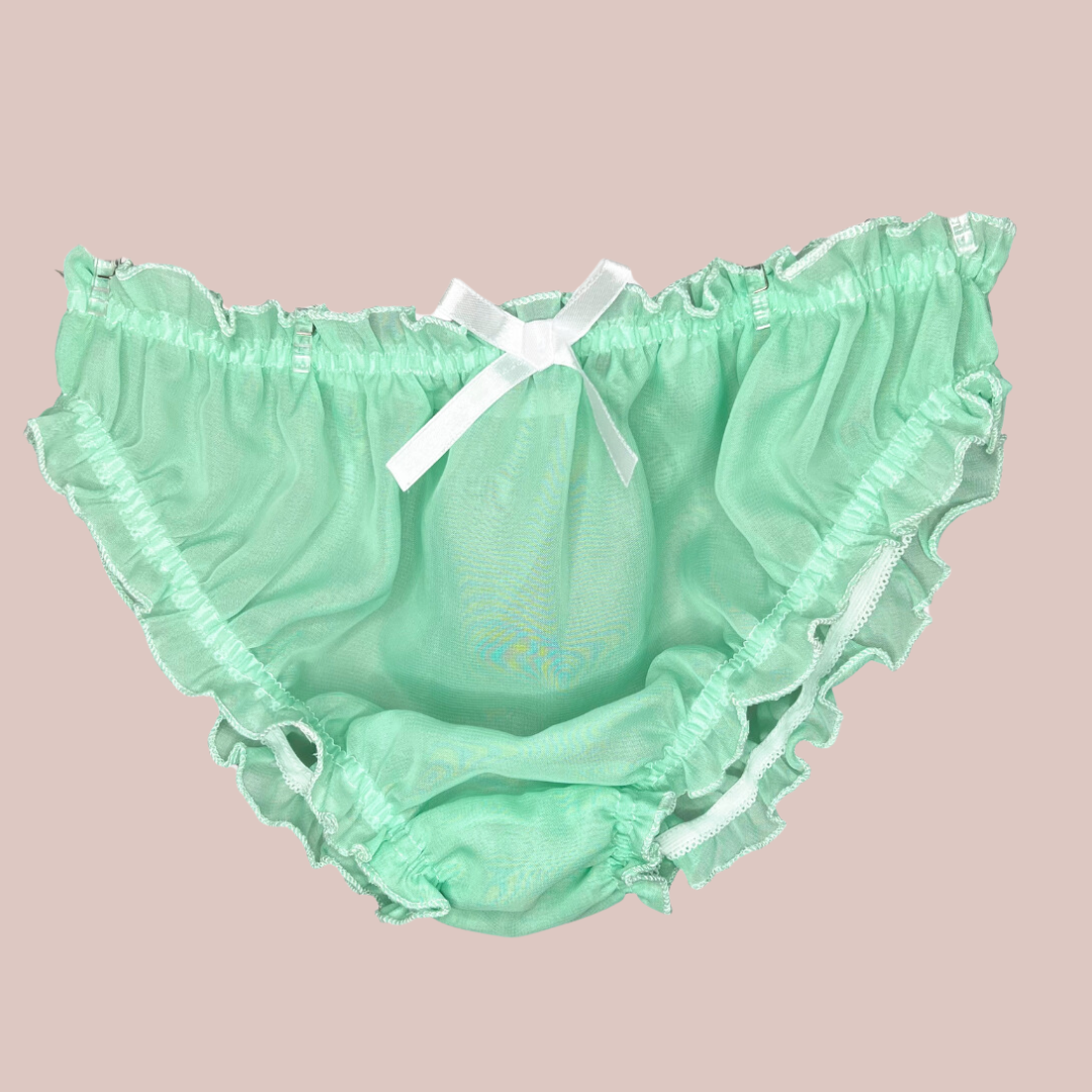 A close up of the green see through panties, the image shows the bikini shape and the depth of see through fabric which allows a man to fit them comfortably.
