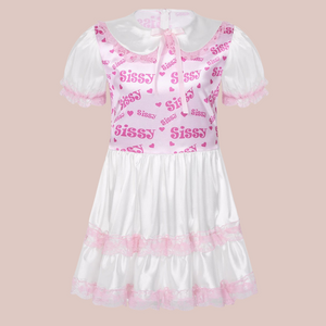 A front view of the Sissy dress, showing a one piece dress with Sissy detailed bodice, white skirt with pink lace and matching white short sleeves. The neckline shows a Peter Pan collar and think satin bow.