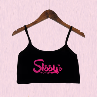 The black crop top camisole from House Of Chastity, shown on a hanger, you can see bold pink Sissy xoxo lettering.