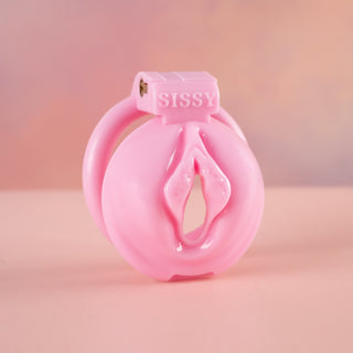 An angled view of The Sissy Pussy Chastity Cage from House Of Chastity. This is a pink cage that comes in a large or small size.