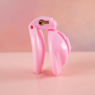 A complete side view of the Sissy Pussy Chastity Cage which shows the narrow depth of the chastity device and how it looks with the base ring and integral lock in place.