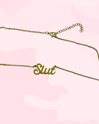 A close up of the Slut pendant which is in a soft itallic lettering.
