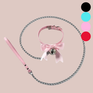 The soft satin bow collar with silver bell and lead is shown here in full. The colours available are shown on the right of the image, black, blue, pink and red.