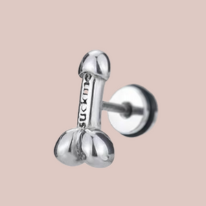 A close up of the siver penis earriings, you can see the they are shaped like a penis with a head and balls.