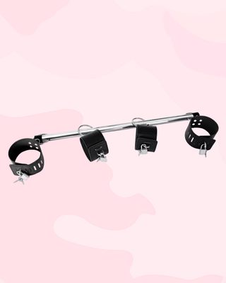 The black pu leather fixed wrist and ankle straps on the spreader bar.