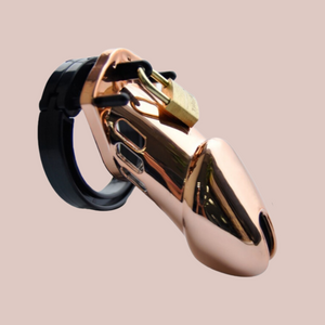 A rose gold medical grade plastic chastity cage that is shown in standard size. This product has a chastity cage, different sized base rings, an external padlock and extra numbered locks.