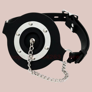 A front view of The Plug Gag, you can see the circular design to the front, the plug is shown fixed in place and the  strap is buckled.