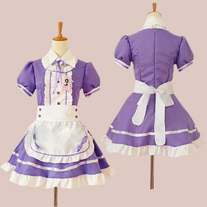 The Suzie purple maids dress, shown with its purple dress, white frilled bib, white frilled edging to the skirt, neck and sleeves, white collar and white half apron with purple bows.