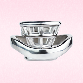 A view of the chastity cage lying on its back, although the cage provides a funnel design, it still provides a flat profile.