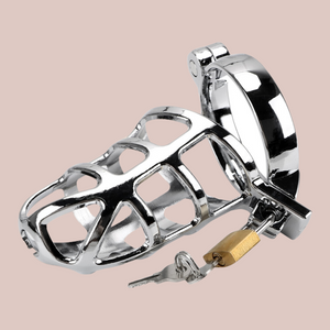 Lying on its back, Made from zinc alloy this chastity cage has a very bright silver look to it, the design to the cage is very web like, hence the name and it is shown here with the base ring and padlock in place.