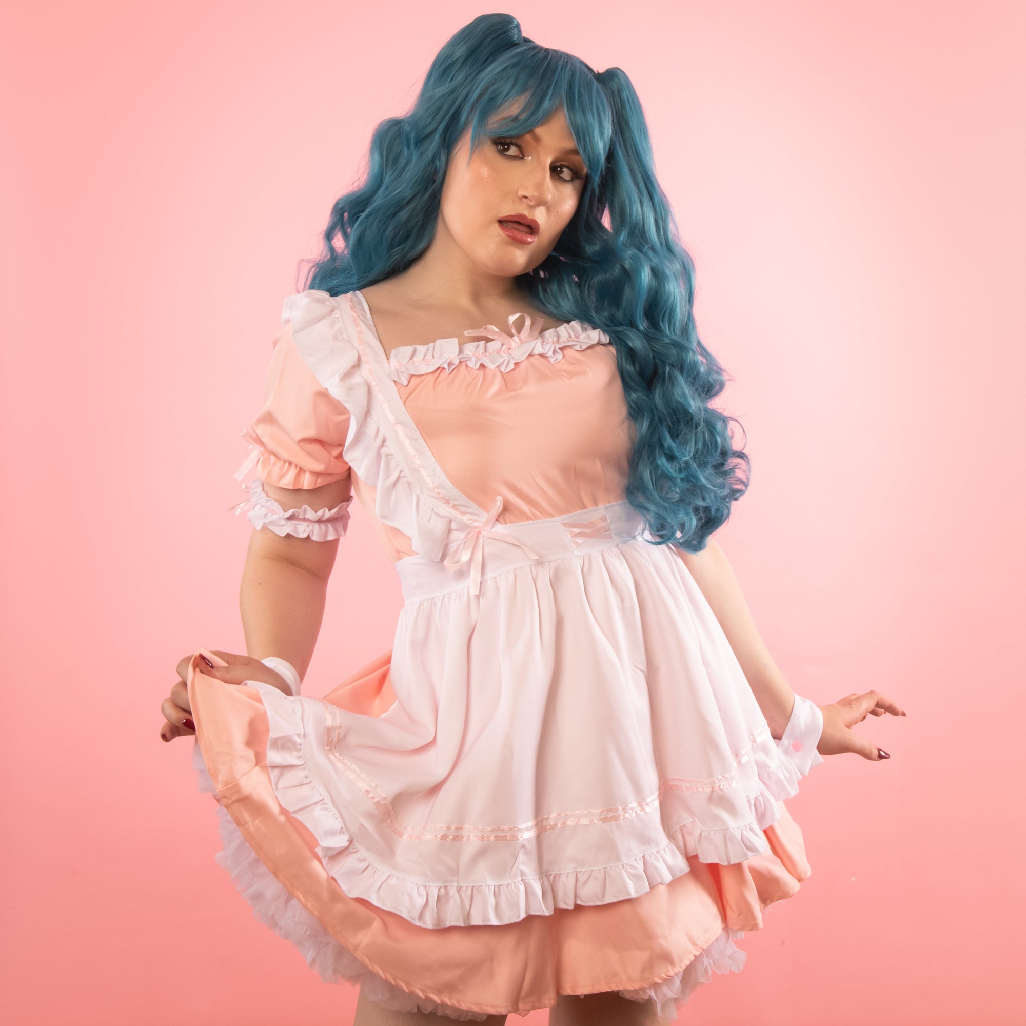 The apron has matching pink ribbon detailing throughout