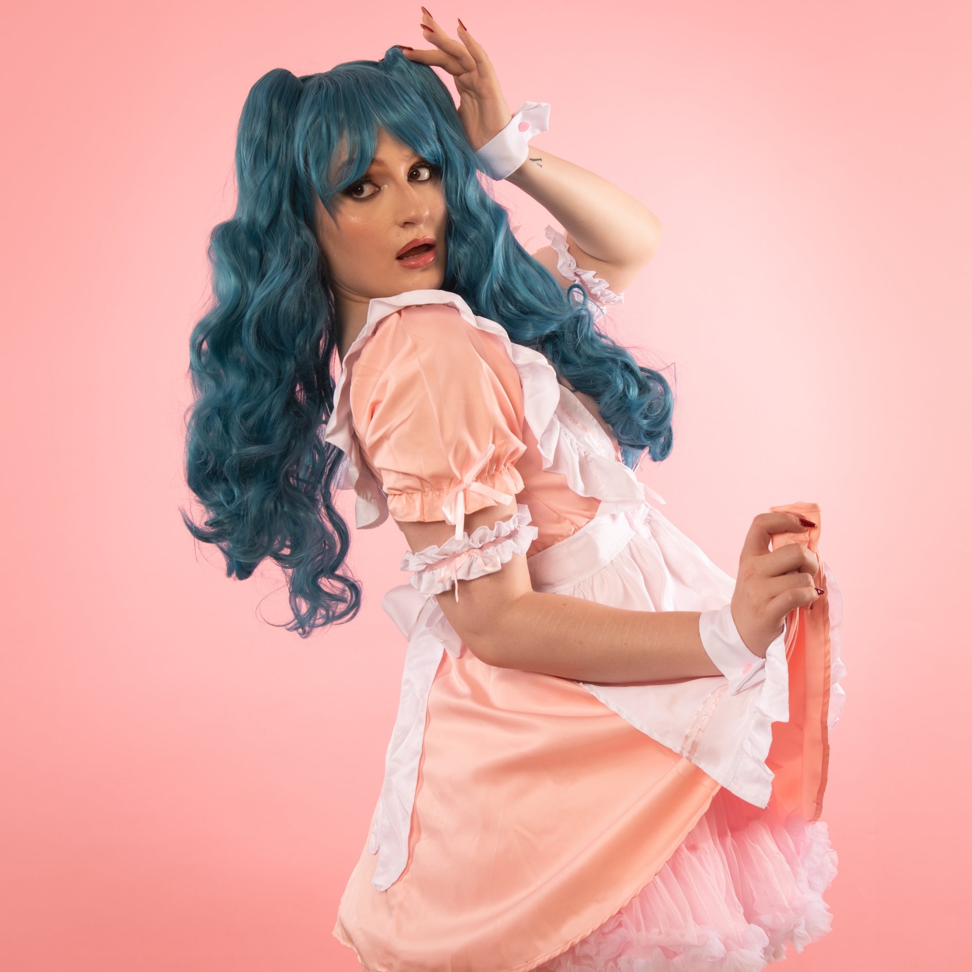 Our model is also wearing our Hoca Modern Curled Wig in blue