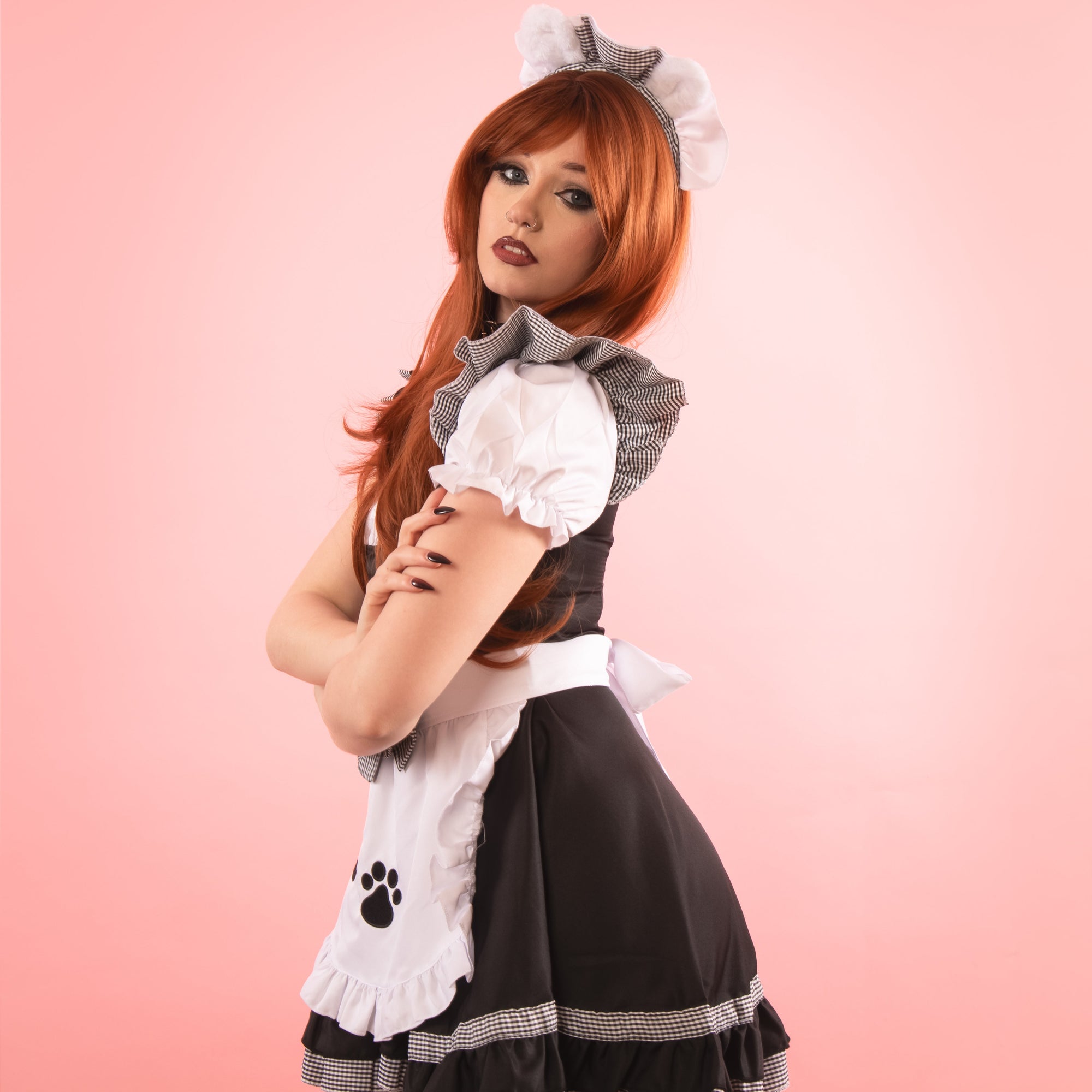 The dress has capped sleeves with frilled edging to the shoulder.