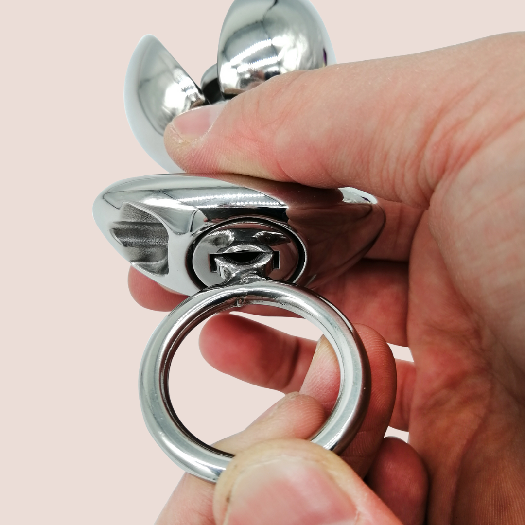 The Blossoming Dilator from House Of Chastity is shown with the handle inserted, it can then be twisted to open the petals.