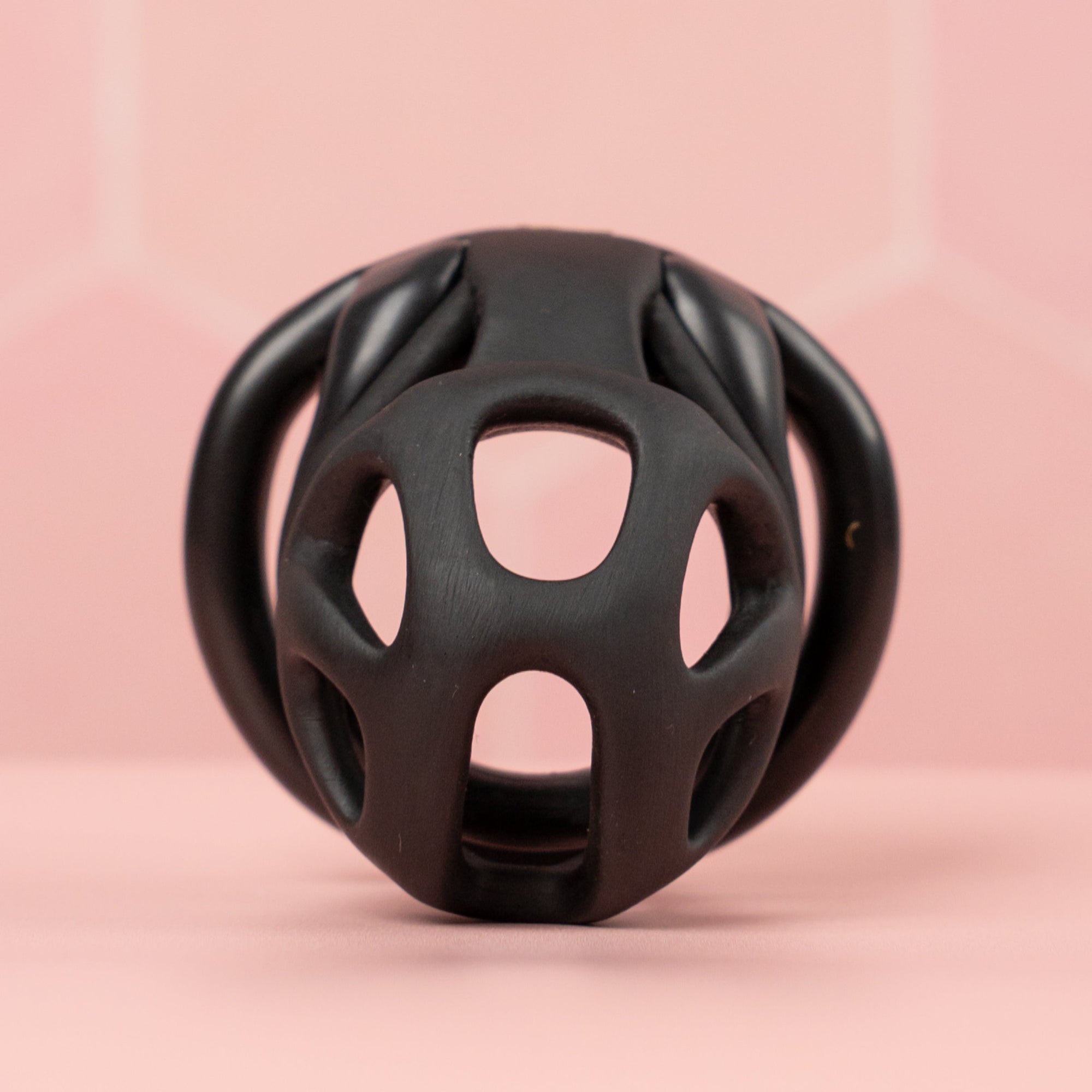 A front on view of the chastity cage, showing the holes designed for ventilation and urination.