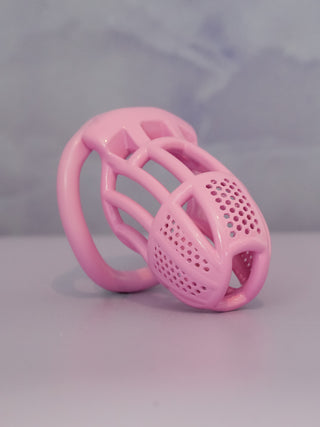 An angled view of the Detained V2 in pink, it is shown on a grey background