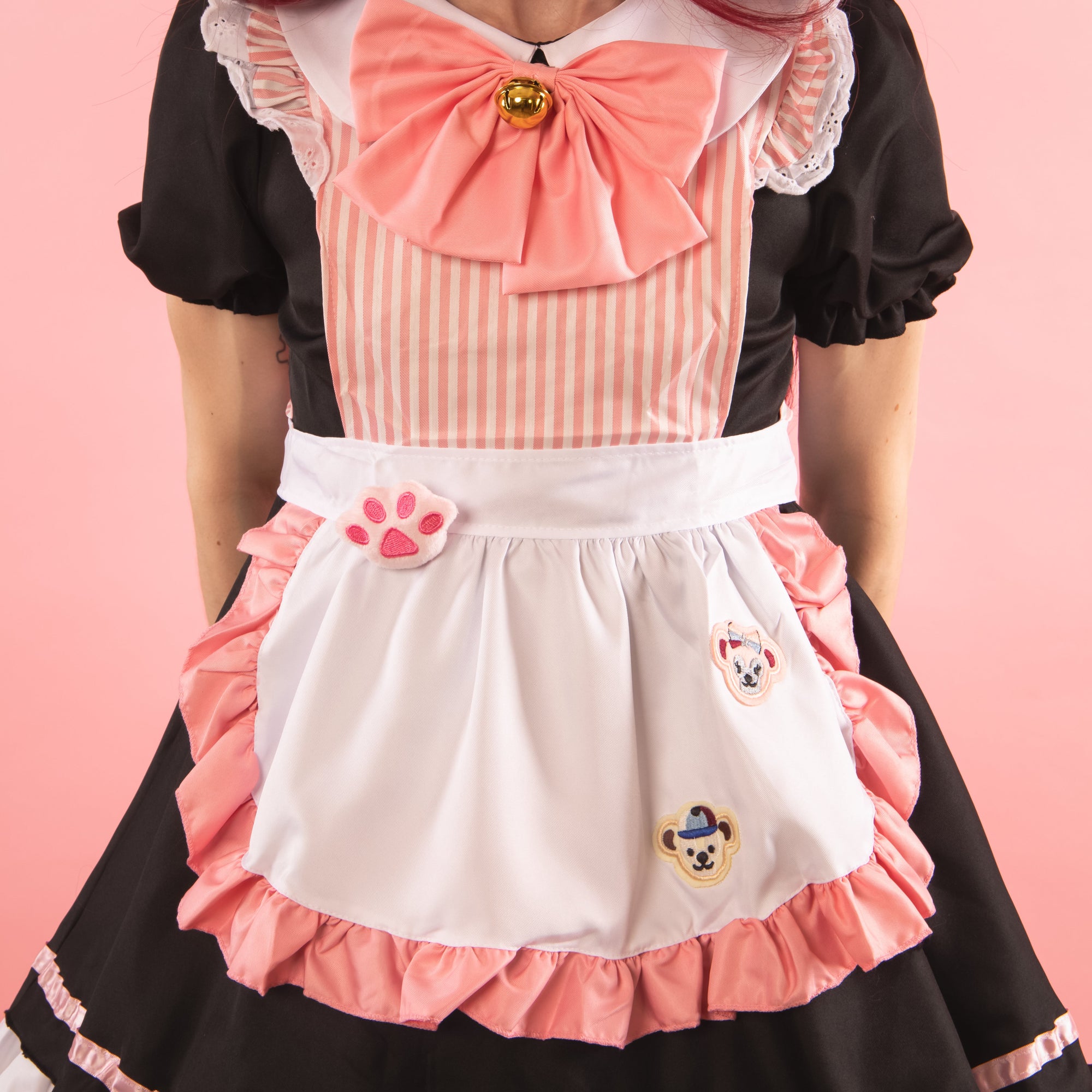 The pretty two tone apron has decorative bear patches and the option bow has a large gold bell.