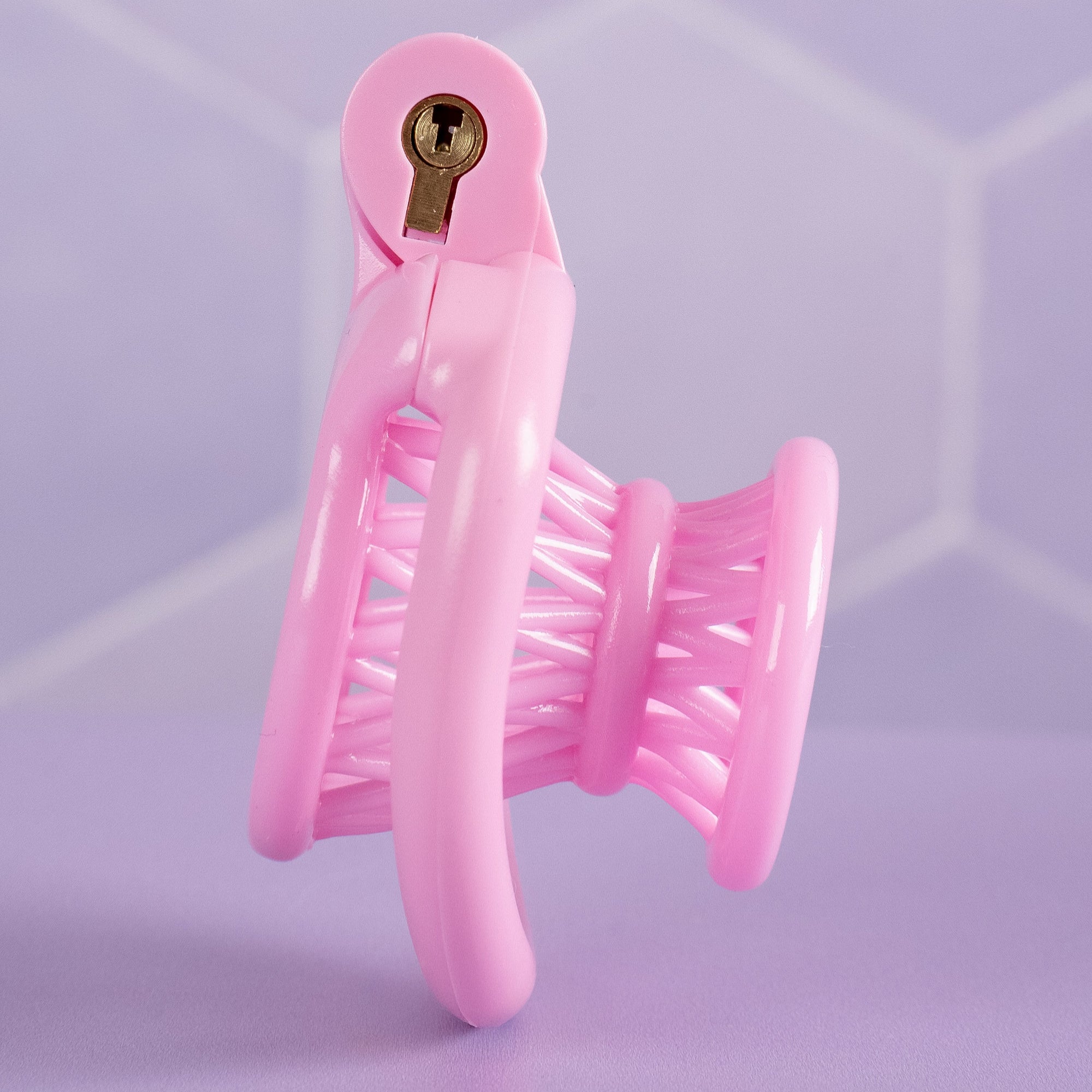 A side view of the pink chastity cage fully assembled.