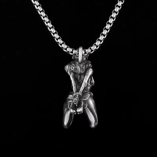 A rear view of the pendant, the figurines arms and ankles are tied.