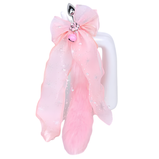 the butt plug with the pure pink tail and pink bow attachment. The paw print and bell can be seen at the centre of the bow.