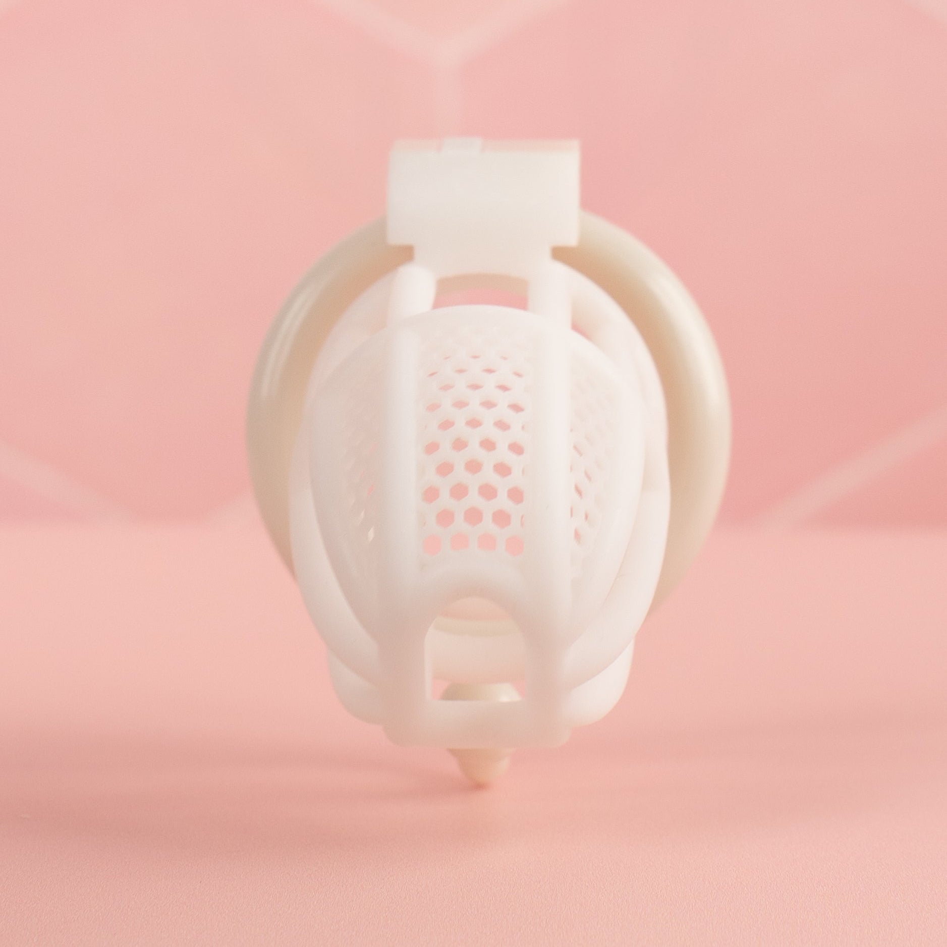A front view of the white Detained chastity cage.