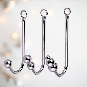 An image showing all three anall ball hooks, from left to right is the single ball, double ball and three ball anal hooks at House Of Chastity.