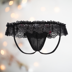 Rear view of low rise hip style knickers with deep lace skirt, penis pouch and two decorative pink bows.