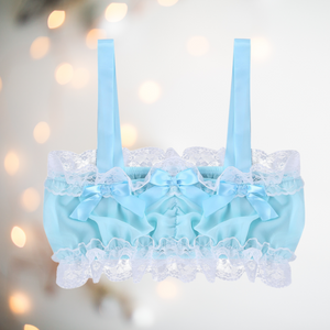 A close up of the baby blue bandeau style bra top, showing the ruched design, lace edging, satin bows and satin shoulder straps.