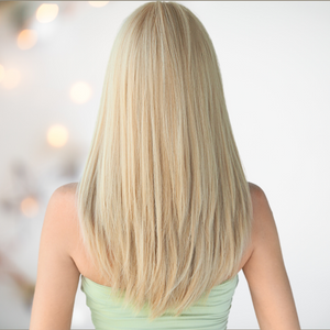 The Long Straight Blonde Bombshell wig from House Of Chastity being modelled. You can see the back of the wig with soft long layered blonde locks
