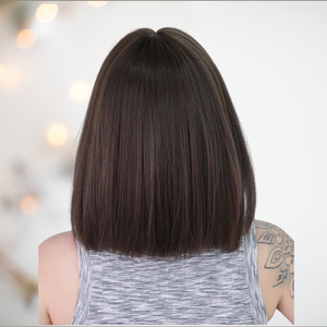 HOC31112 Brown Sleek Length Hair. This is a dark brown wig that has been styled into a sleek bob style and is designed to brush the shoulders. It also has a face softeningly blunt fringe. View of the rear of the wig illustrating the straight cut.