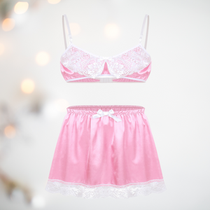 A pretty bra and petticoat set for men, the bra comes in satin baby pink with a lace decoration to the cups, thin white bra straps and a matching satin above knee petticoat with white lace edging detail and matching white satin bow detail. 