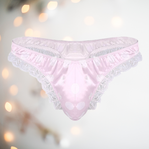 A soft pale pink satin mens female style knickers. They have a white spot design on the pink fabric, white lace edging to the legs and a thong style back.