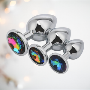 The Multi Coloured Jewelled Butt Plug Set from House Of Chastity. This set includes a small, medium and large butt plug made from stainless steel and with a pretty jewelled base.