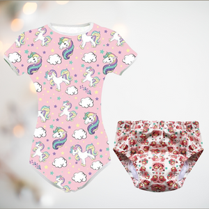 pink adult baby bodysuit with unicorns and clouds, along with a fabric nappy or diaper.