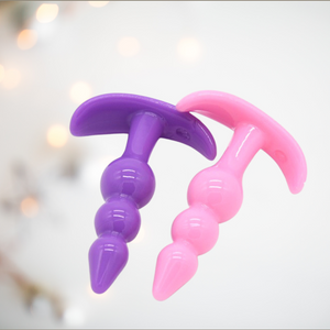 House Of Chastity now has pink and purple small anal butt plugs on offer, shown here are the triple bead plugs purple on the left and pink on the right.